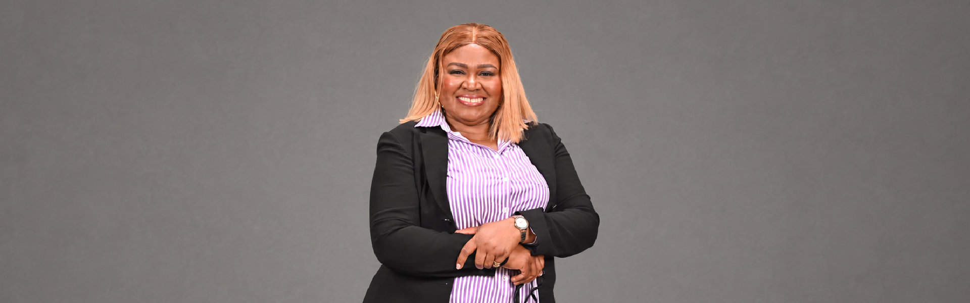 professional woman dressed in a purple shirt and black blazer